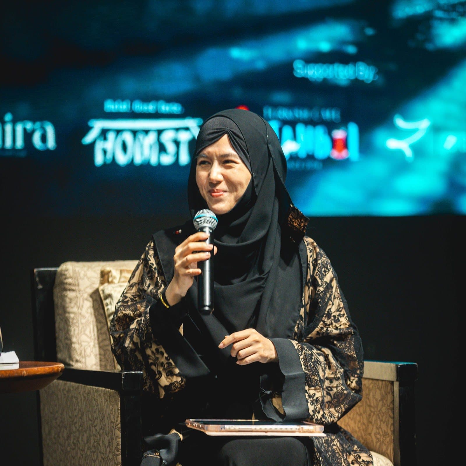 A guest sharing her experience during a panel session at NMCC 2025